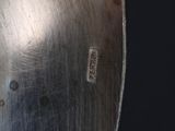 a close up of a metal object on a table with a black background