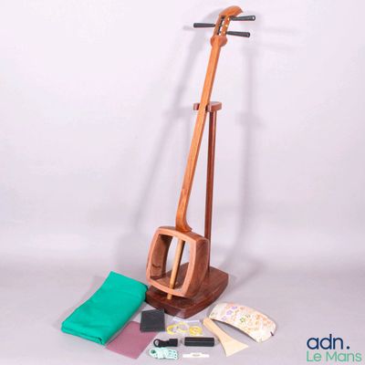 an image of a wooden instrument with a green cloth and other items