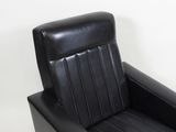 black leather recliner chair on white background with white wall