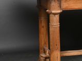 an old wooden table with a wooden top on a grey background