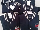 four men ' s baseball uniforms are laid out on a table
