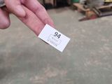 a person holding a cell phone with a price tag on it