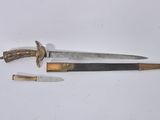 two knives are laying next to each other on a white surface