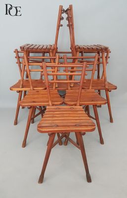 six wooden chairs and a table in a room