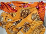 many different types of scarves laid out on a table