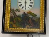 une horloge accrochée au mur, à côté d'un tableau représentant un homme et un chien