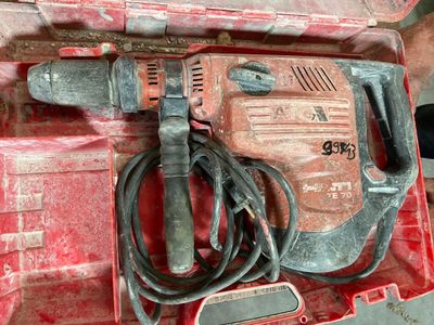 a red box with a drill and a cord in it