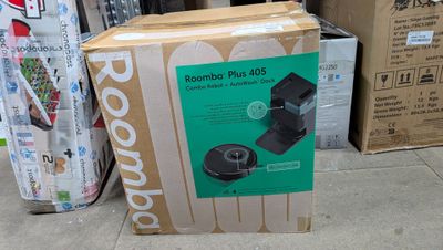 a cardboard box that is sitting on the ground next to a pile of boxes