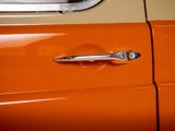 a close up of an orange car door handle