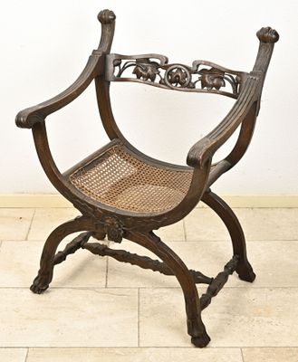 a wooden chair that is sitting on a tile floor