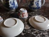 three cups and a saucer sitting on a table