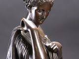 an image of a bronze statue of a woman with her hands on her face