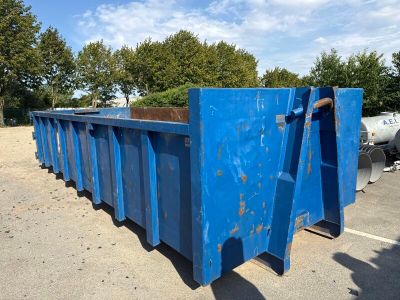 a blue dumpster that is sitting in the parking lot