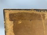 an old book sitting on top of a table with writing on it