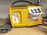 a small yellow machine with a price tag on it