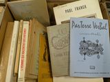 a box full of books that are stacked on top of each other