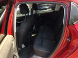 a red car with its door open and the seats down