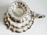 a silver plate with a handle on it
