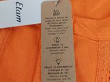 an orange shirt with a tag attached to it ' s chest
