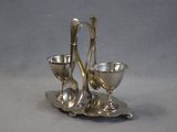 a silver plate with a spoon and two cups on it
