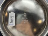 someone is holding a silver pot with a label on it