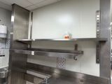 a large kitchen with stainless steel cabinets and a stove