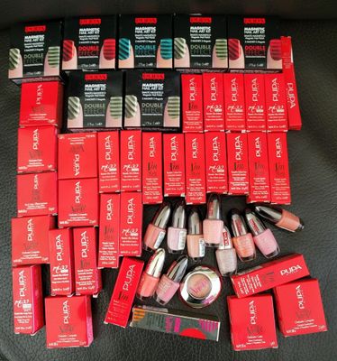some of the lipsticks are sitting on the black surface