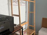a wooden shelf with a printer on it in a room