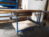 a blue cart with a wooden table on it