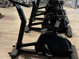 a row of stationary exercise bikes in a gym