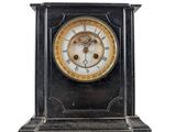 a black and gold clock with a white face