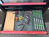 a tool drawer with tools in it on the floor