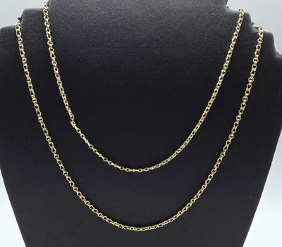 a gold chain necklace on a mannequin display