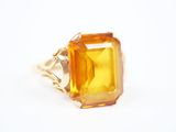 Gros plan sur une bague contenant une pierre jaune