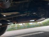a close up view of a car ' s exhaust pipe and exhaust muffler