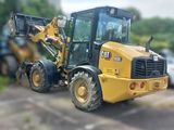 a yellow tractor that is parked in a parking lot
