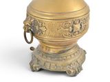 a gold vase with a handle on a white background