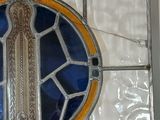 a stained glass window with a picture of a cross on it