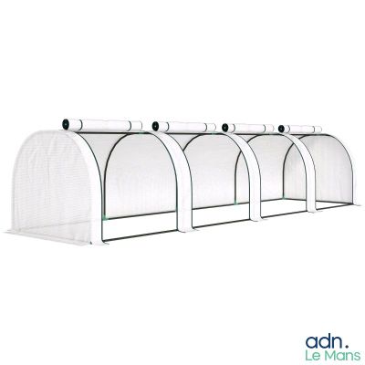 a group of four greenhouse tunnels with a white cover