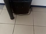 a black paper shredder sitting on the floor next to a black pole