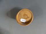 a small wooden bowl with a label on it