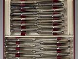 a bunch of knives in a case on a table