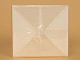 a white box with a bow on it on a brown surface