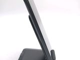 a cell phone on a stand on a white surface