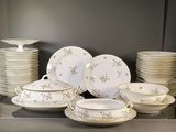 a lot of plates and bowls on the counter