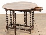an old wooden table with a drawer underneath it on a wooden floor