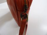 a red purse that is sitting on a white table