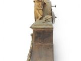 statue of an angel holding a sword on a wooden stand