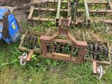 a blue tractor that is sitting in the grass