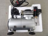 an image of a small air compressor on a table